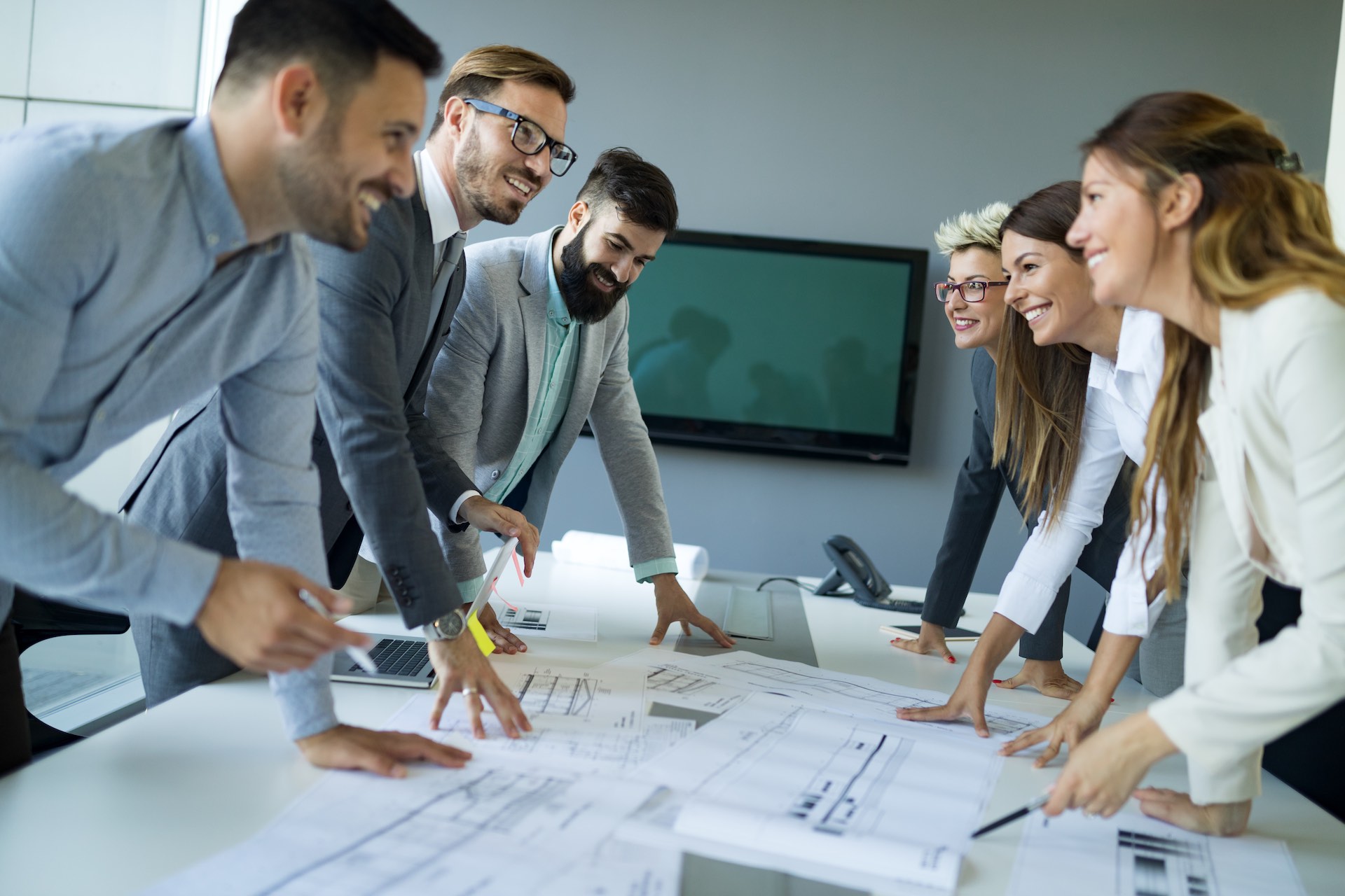 Team of architects working on construction plans together